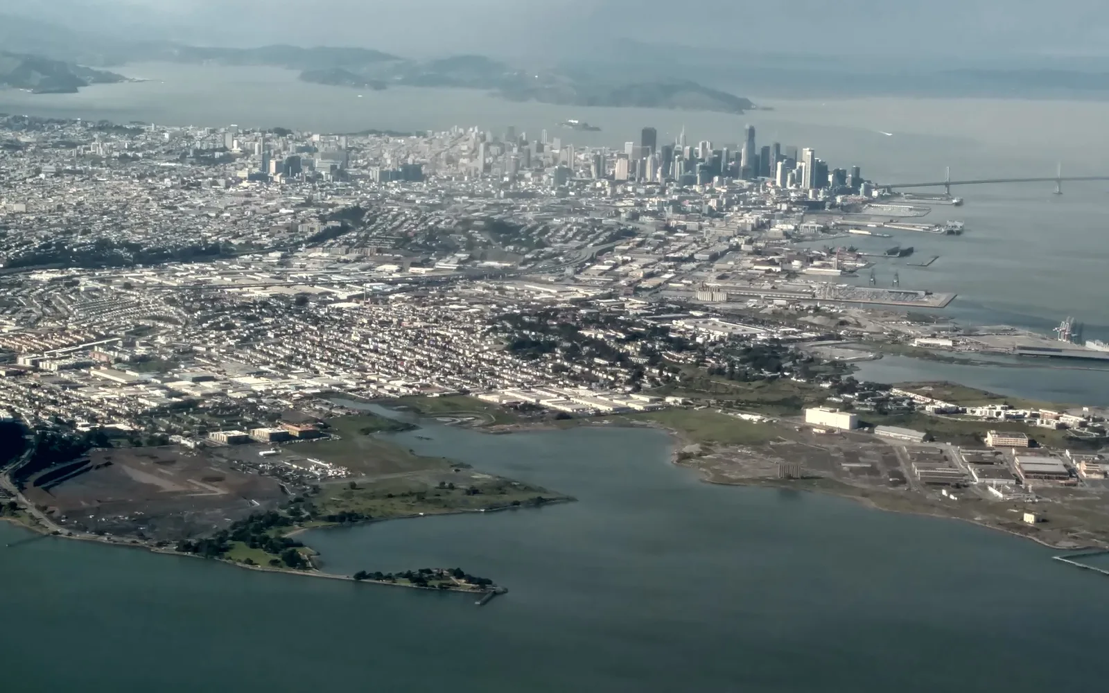 Aerial view of the San Francisco Peninsula taken from a commercial aircraft, showing the distinctive geography and landscape character of the peninsula